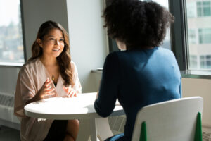 Business owner confidently sharing a downsell as a recommendation during a client conversation.