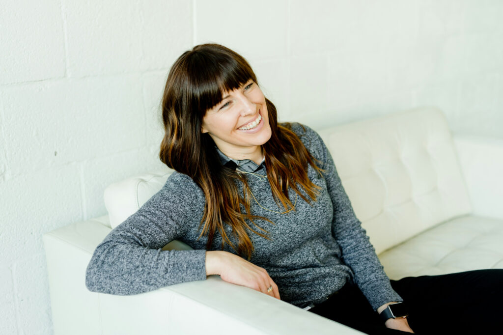 Relaxed business owner smiling because her business growth strategies are working.