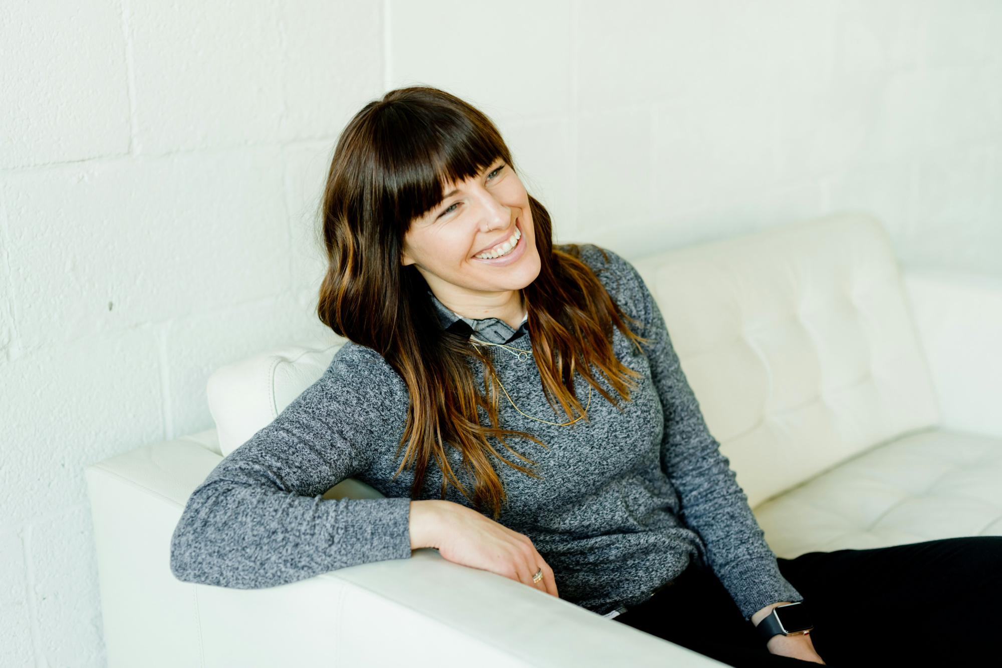 Relaxed business owner smiling because her business growth strategies are working.
