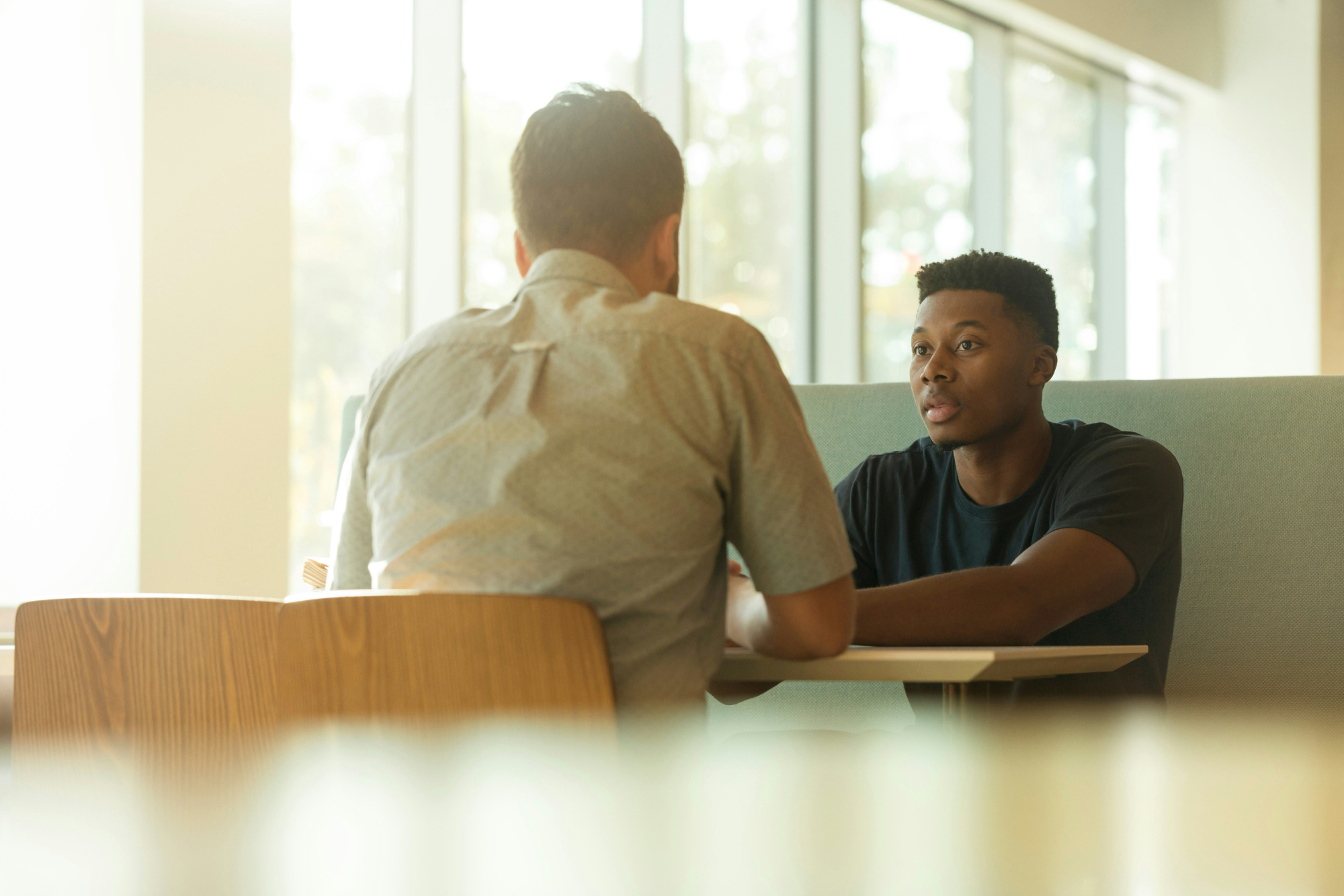 Client has guarded expression during a cross-selling conversation.